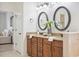 This bathroom features a double sink vanity with a granite countertop at 1108 Stoney Creek Blvd, Lakeland, FL 33811