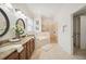 This bathroom features a granite double sink vanity, a soaking tub, and a glass shower at 1108 Stoney Creek Blvd, Lakeland, FL 33811