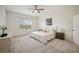 This bright bedroom features neutral decor, a ceiling fan, and large windows at 1108 Stoney Creek Blvd, Lakeland, FL 33811