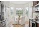 Charming breakfast nook features natural lighting, a white table setting for four, and tiled flooring at 1108 Stoney Creek Blvd, Lakeland, FL 33811