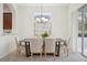 This dining room has a modern chandelier and sliding glass doors to the outside patio at 1108 Stoney Creek Blvd, Lakeland, FL 33811