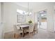 Well-lit dining room with a modern chandelier, neutral tones, and convenient access to the outdoor patio at 1108 Stoney Creek Blvd, Lakeland, FL 33811