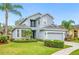 Charming two-story home features a well-manicured lawn, a two-car garage, and a welcoming front porch at 1108 Stoney Creek Blvd, Lakeland, FL 33811