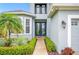 Inviting front entrance features a walkway lined with shrubbery leading to beautiful double doors at 1108 Stoney Creek Blvd, Lakeland, FL 33811