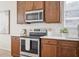 Kitchen featuring stainless steel appliances, white quartz countertops, and rich dark wooden cabinetry at 1108 Stoney Creek Blvd, Lakeland, FL 33811