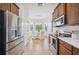 Well-equipped kitchen with stainless steel appliances, tiled flooring, and cozy breakfast nook in natural light at 1108 Stoney Creek Blvd, Lakeland, FL 33811