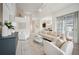 Bright living room with vaulted ceilings, neutral decor, and a view of the dining room at 1108 Stoney Creek Blvd, Lakeland, FL 33811