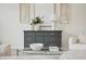 Bright living room featuring neutral decor, a stylish gray dresser, and a glass coffee table at 1108 Stoney Creek Blvd, Lakeland, FL 33811