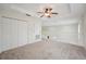 Bright loft area featuring neutral carpeting, a ceiling fan, and a white railing overlooking the floor below at 1108 Stoney Creek Blvd, Lakeland, FL 33811