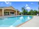 Community pool with a covered lounge area, perfect for relaxing and enjoying the sunny weather at 1108 Stoney Creek Blvd, Lakeland, FL 33811