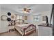 A cozy bedroom featuring a wood bed frame, ceiling fan, and natural light from the windows at 111 Klein Ct, Lakeland, FL 33813