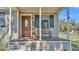 Inviting front porch with rocking bench, wood door, and stylish accents for relaxation at 111 Klein Ct, Lakeland, FL 33813