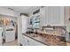 Bright kitchen features stainless steel sink, ample counter space, and white cabinetry at 111 Klein Ct, Lakeland, FL 33813