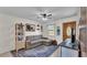 Cozy living room featuring a comfortable sofa, ceiling fan, and natural light at 111 Klein Ct, Lakeland, FL 33813