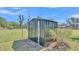 View of black metal outdoor shed with a single door and a fenced perimeter at 111 Klein Ct, Lakeland, FL 33813