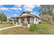 View of single story home featuring a charming front porch with decorative railing and landscaping at 1243 Olive St, Lakeland, FL 33815