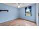 Bedroom with a ceiling fan, light blue walls, wood-look floors, and window at 1415 Pinewood Ave, Lakeland, FL 33803