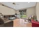 Bright living room with hardwood floors, a ceiling fan, and sliding glass doors to the backyard at 1415 Pinewood Ave, Lakeland, FL 33803