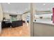 Bright living room with hardwood floors, a ceiling fan, and sliding glass doors to the backyard at 1415 Pinewood Ave, Lakeland, FL 33803