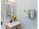 Well-lit powder room with a stylish vanity, mirror, and fresh towels at 14439 Prunningwood Pl, Winter Garden, FL 34787