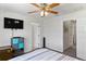 This airy bedroom features multiple doorways, TV, ceiling fan, and neutral walls and carpet at 14439 Prunningwood Pl, Winter Garden, FL 34787