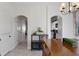 Open dining area with arched entries, table with seating, and view into kitchen at 14439 Prunningwood Pl, Winter Garden, FL 34787