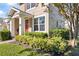 Townhome exterior featuring a well-manicured lawn and colorful landscaping at 14439 Prunningwood Pl, Winter Garden, FL 34787