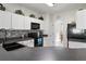 Bright kitchen with white cabinets, black appliances, and gray countertops at 14439 Prunningwood Pl, Winter Garden, FL 34787