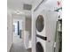 Hallway with a laundry closet featuring a stackable washer and dryer and extra storage at 14439 Prunningwood Pl, Winter Garden, FL 34787