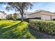 Exterior view showing the lawn and landscaping surrounding this property at 14439 Prunningwood Pl, Winter Garden, FL 34787