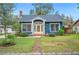 Charming blue home with a brick path leading to a bright yellow front door at 1618 Robertson St, Lakeland, FL 33803