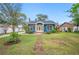 Charming blue home with a brick path leading to a bright yellow front door at 1618 Robertson St, Lakeland, FL 33803