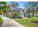 Charming blue home with a brick chimney, complemented by a well-manicured lawn at 1618 Robertson St, Lakeland, FL 33803