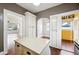 Open kitchen with white cabinetry, center island, and multiple doorways, creating an easy flow at 1618 Robertson St, Lakeland, FL 33803