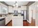 Bright kitchen with stainless steel appliances, including a refrigerator with water dispenser, and classic cabinets at 1618 Robertson St, Lakeland, FL 33803