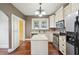 Traditional kitchen featuring stainless steel appliances, a center island, and classic cabinetry at 1618 Robertson St, Lakeland, FL 33803