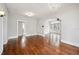 Spacious living room with hardwood floors, textured walls, arched doorway, and elegant chandelier at 1618 Robertson St, Lakeland, FL 33803