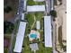 Aerial view of the complex showcasing multiple buildings, green space, and sparkling pool at 1700 6Th Nw St # A36, Winter Haven, FL 33881