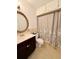 Bathroom features a classic vanity, decorative mirror, toilet, and shower with neutral accents at 1700 6Th Nw St # A36, Winter Haven, FL 33881