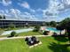 Beautiful condominium community with a pool, shuffleboard courts, and grill area at 1700 6Th Nw St # A36, Winter Haven, FL 33881