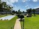 Beautiful condominium community with shuffleboard courts, lush landscaping, and a swimming pool at 1700 6Th Nw St # A36, Winter Haven, FL 33881