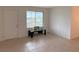 Bright living room with tile floors, a large window, and glass coffee table at 1700 6Th Nw St # A36, Winter Haven, FL 33881