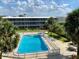 Aerial view of a community pool surrounded by lush tropical landscaping at 1700 6Th Nw St # A36, Winter Haven, FL 33881