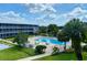 Beautiful view of the refreshing community pool with seating and lush landscaping at 1700 6Th Nw St # A36, Winter Haven, FL 33881