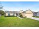 Inviting single-story home with well-kept lawn, two-car garage, and screened front porch at 1888 Creeks Vista Blvd, Lakeland, FL 33810