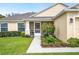 Close-up of the home's entrance with a screened porch and colorful garden at 1888 Creeks Vista Blvd, Lakeland, FL 33810