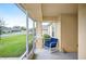 Screened-in front porch with a blue rocking chair overlooking the landscaped yard at 1888 Creeks Vista Blvd, Lakeland, FL 33810