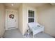 Welcoming front porch with a floral wreath, white chair, and a friendly Dalmatian at 1888 Creeks Vista Blvd, Lakeland, FL 33810