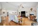 Bright and open living room with hardwood floors, fireplace, and a view into the kitchen at 1888 Creeks Vista Blvd, Lakeland, FL 33810