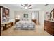 Spacious main bedroom with ceiling fan, plush carpet, and warm, inviting decor at 1888 Creeks Vista Blvd, Lakeland, FL 33810